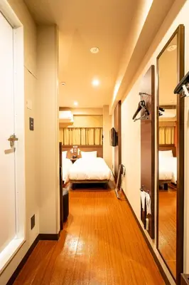 a hotel room with a bed and a mirror at Red Roof Inn Kamata / Haneda Tokyo in Tokyo