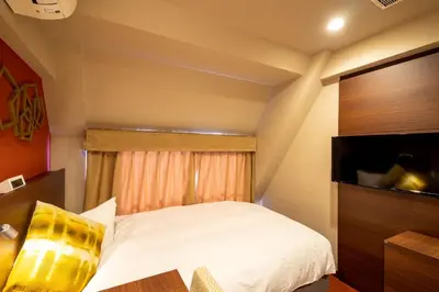 a bedroom with a white bed and a window at Red Roof Inn Kamata / Haneda Tokyo in Tokyo