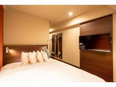 a bedroom with a bed and a flat screen tv at Red Roof Inn Kamata / Haneda Tokyo in Tokyo