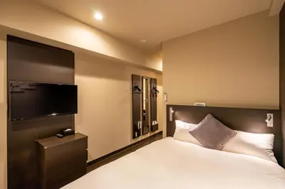 a bedroom with a bed and a flat screen tv at Red Roof Inn Kamata / Haneda Tokyo in Tokyo