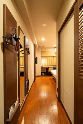 a hallway leading to a room with a bed and a door at Red Roof Inn Kamata / Haneda Tokyo in Tokyo