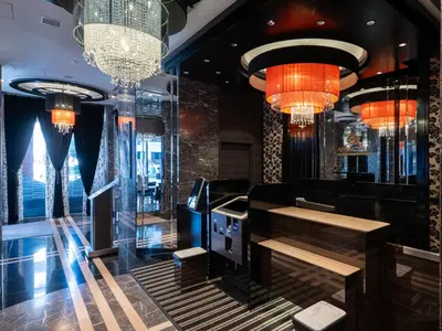 a bar with chandeliers and a bench in a room at APA Hotel Higashi Shinjuku Kabukicho Higashi in Tokyo
