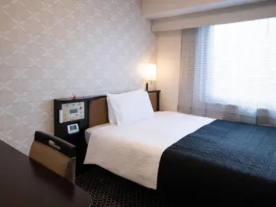 a hotel room with a bed and a window at APA Hotel Higashi Shinjuku Kabukicho Higashi in Tokyo