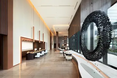 a lobby with a large wreath on the wall at Ascott Marunouchi Tokyo in Tokyo