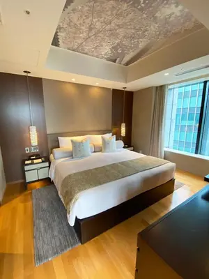 a bedroom with a large bed with a coffered ceiling at Ascott Marunouchi Tokyo in Tokyo
