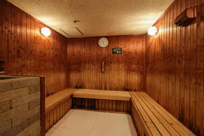 a room with a sauna with a clock on the wall at Bayside Hotel Azur Takeshiba in Tokyo