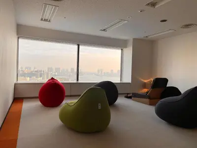 a living room with chairs and a large window at Bayside Hotel Azur Takeshiba in Tokyo
