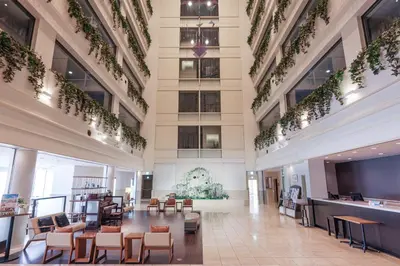 a lobby of a building with chairs and tables at Bayside Hotel Azur Takeshiba in Tokyo