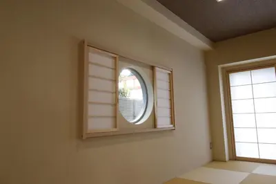 a room with a window with a mirror at Yanaka Kotobuki Sou in Tokyo