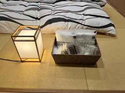a box sitting on the floor next to a bed at Yanaka Kotobuki Sou in Tokyo
