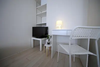 a room with a desk and a tv and a chair at The Sorapia Tokyo in Tokyo