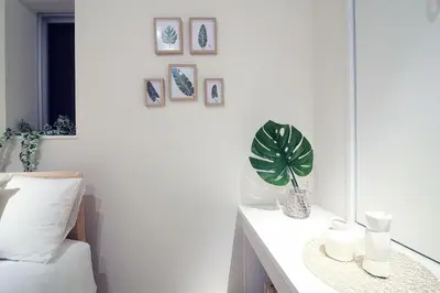 a bedroom with a desk and a plant on a wall at The Sorapia Tokyo in Tokyo