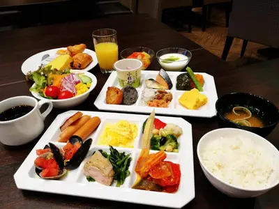 a table with three plates of food on it at Hiyori Hotel Maihama in Urayasu