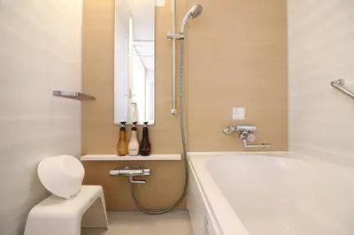a bathroom with a tub and a toilet and a sink at Hiyori Hotel Maihama in Urayasu