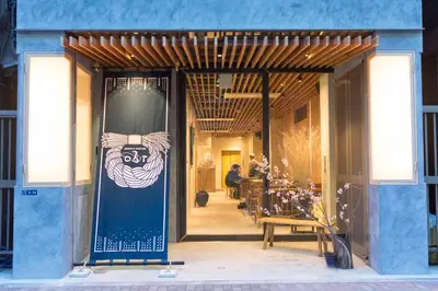 a lobby with a blue wall with a sign on it at obi Hostel in Tokyo