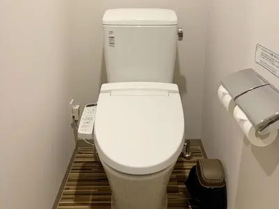 a white toilet in a bathroom with two rolls of toilet paper at Henn na Hotel Maihama Tokyo Bay in Urayasu