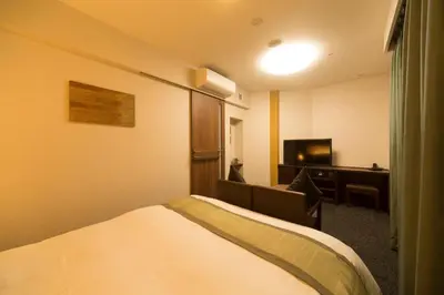 a hotel room with a bed and a television at Dormy Inn Premium Kanda in Tokyo