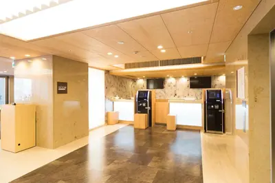 a large kitchen with black appliances in a building at Dormy Inn Premium Kanda in Tokyo