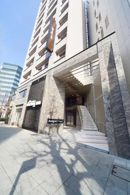 a building with a staircase in front of a building at Dormy Inn Premium Kanda in Tokyo