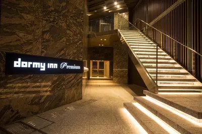 a stairway in a building with a sign on it at Dormy Inn Premium Kanda in Tokyo