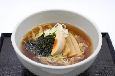 a bowl of noodle soup with bananas and other ingredients at Dormy Inn Premium Kanda in Tokyo