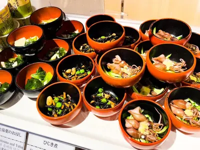 a bunch of bowls of food on a table at Dormy Inn Premium Kanda in Tokyo