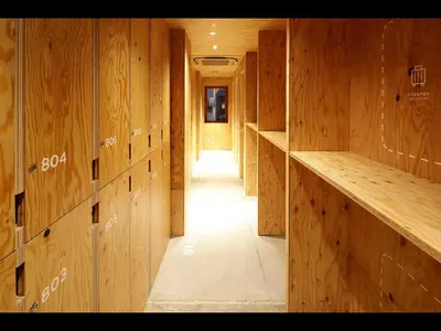 a hallway with wood paneled walls and a long corridor at Do-c Shibuya Ebisu in Tokyo