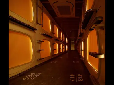 an empty hallway of a train car with windows at Do-c Shibuya Ebisu in Tokyo