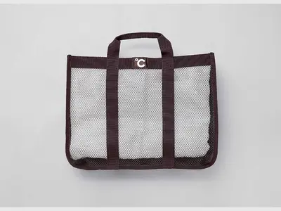 a black and white bag on a white background at Do-c Shibuya Ebisu in Tokyo