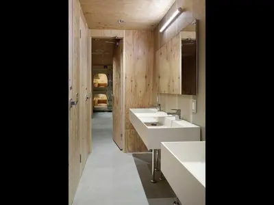 a bathroom with two sinks and wooden walls at Do-C Gotanda in Tokyo