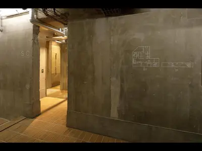 an empty hallway with a wall with a drawing on it at Do-C Gotanda in Tokyo
