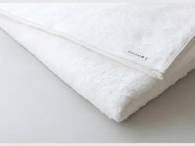 a white pillow with the word mattress on it at Do-C Gotanda in Tokyo