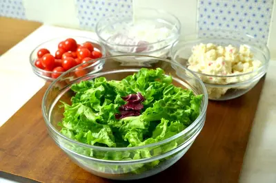 a group of bowls of lettuce and tomatoes on a table at Rembrandt Style Tokyo Nishikasai Grande in Tokyo