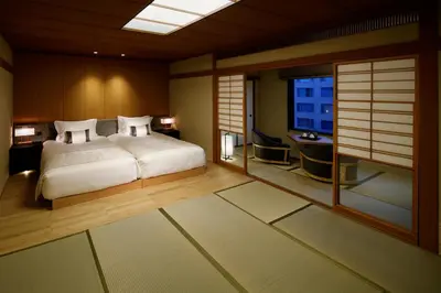 a bedroom with a bed and a desk and a window at Takanawa Hanakohro, a Member of Small Luxury Hotels of the World in Tokyo