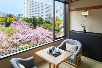a room with two chairs and a table and a large window at Takanawa Hanakohro, a Member of Small Luxury Hotels of the World in Tokyo
