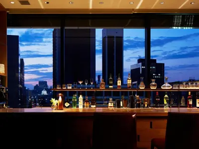 a bar with a view of a city skyline at Hotel The Celestine Ginza in Tokyo