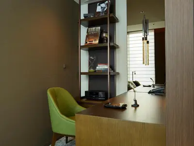 an office with a desk and a green chair at Hotel The Celestine Ginza in Tokyo