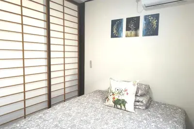 a bedroom with a bed with a pillow on it at Kiki HouseH --Self Check-in -- Room Number & Password is in the following email in Tokyo
