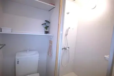 a white bathroom with a shower and a toilet at Kiki HouseH --Self Check-in -- Room Number & Password is in the following email in Tokyo