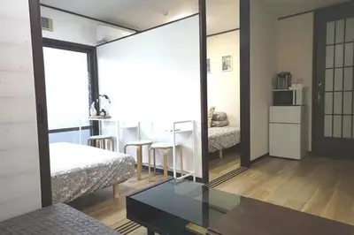 a room with a mirror and a bed and a table at Kiki HouseH --Self Check-in -- Room Number & Password is in the following email in Tokyo