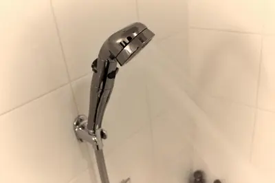 a shower head on a wall in a bathroom at Hotel Sunroute Stellar Ueno in Tokyo