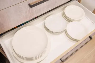 four white bowls on a shelf in a drawer at PREMIER suite Shinjuku West 3F 4F in Tokyo