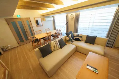 a living room with a couch and a table at PREMIER suite Shinjuku West 3F 4F in Tokyo