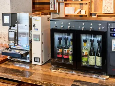 a group of bottles of wine in a machine at ONE@Tokyo by insomnia in Tokyo