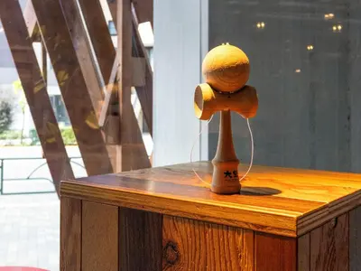 a stuffed animal is on a wooden table at ONE@Tokyo by insomnia in Tokyo