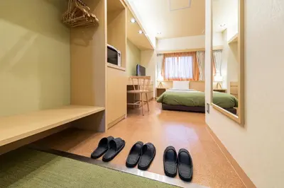 a room with two pairs of shoes on the floor at Akasaka Yoko Hotel in Tokyo