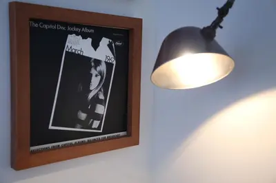 a picture of a girl on a wall with a lamp at TRUNK(HOTEL)CAT STREET in Tokyo