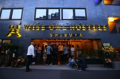a group of people standing outside of a building at Wise Owl Hostels Shibuya in Tokyo