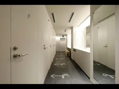 a hallway with white walls and drawings on the floor at 9h nine hours woman Kanda in Tokyo