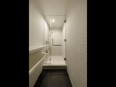 a bathroom with a walk in shower and white tiles at 9h nine hours woman Kanda in Tokyo
